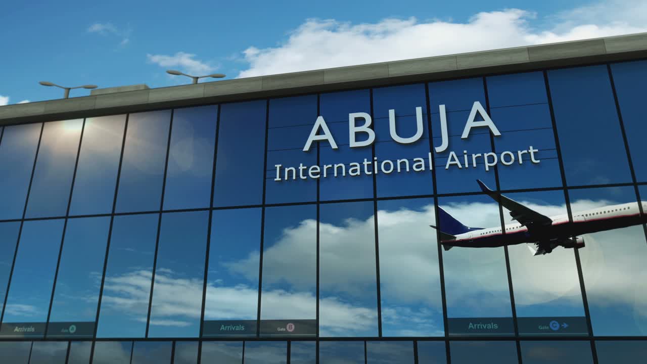 Airplane landing at Abuja Nigeria airport mirrored in terminal
