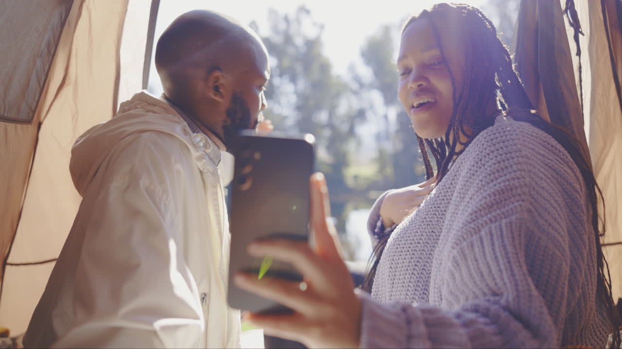 Camping, phone video call and a black couple
