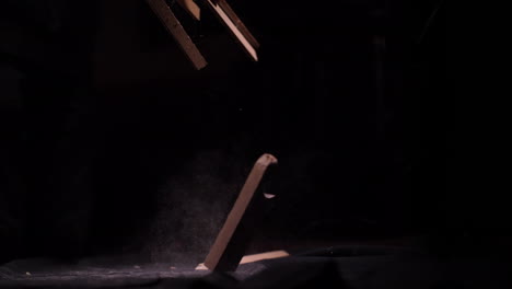 Old-Dusty-Scrap-Wood-Falling-on-the-Ground-in-Black-Studio