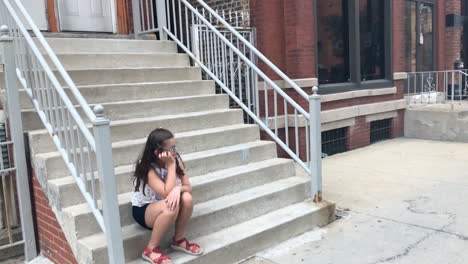 young girl sitting on apartment streets on street in chicago