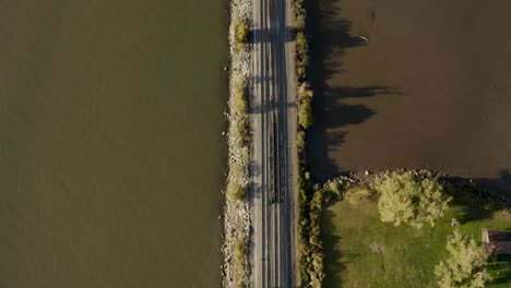 4k-Aerial-pan-up-shot-of-train-track-to-mountain