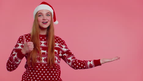 Woman-wears-red-New-Year-sweater-deer-showing-thumbs-up-and-pointing-at-on-blank-advertisement-space