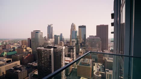 shot overlooking the railing of a high rise building showcasing the iconic downtown minneapolis skyline