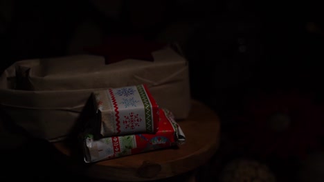 light and shadow in front of small christmas gifts with wooden decorations in the background