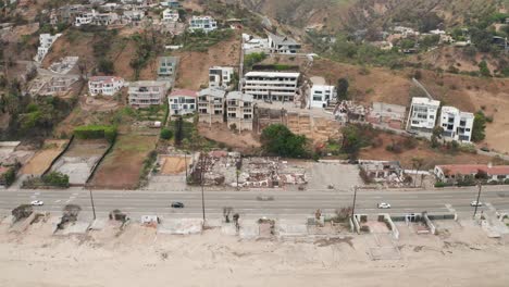 wide aerial dolly shot of cleared lots along pacific coast highway at las flores canyon after the wildfire in malibu, california. 4k