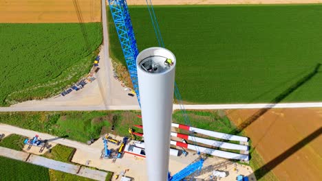 technician at work inside the tower of a wind turbine during erection at wind farm in austria