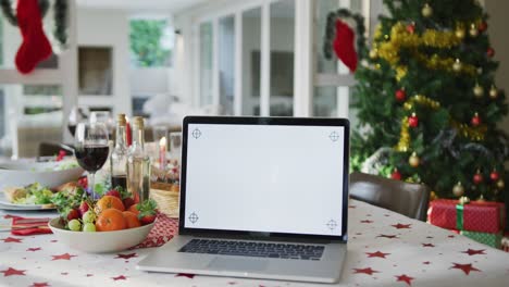 Laptop-with-copy-space-on-screen-lying-on-christmas-table