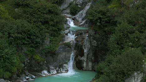 Slow-motion-of-mountain-waterfall-in-Furka-Pass-valley-of-Switzerland-in-summer-season