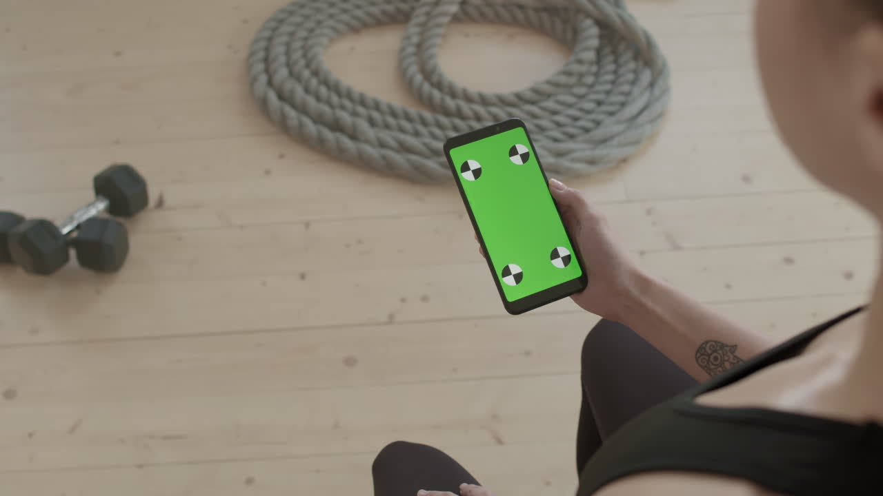 Sports Girl Using Smartphone At Workout