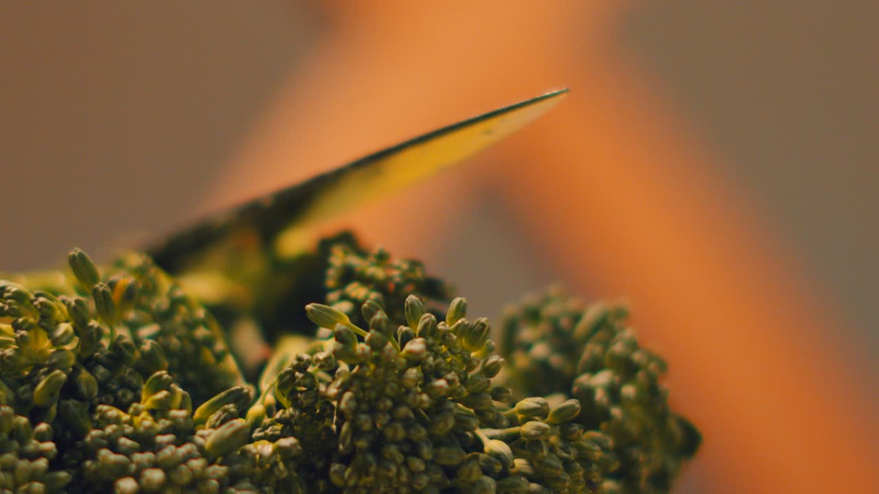 Knife Resting on Top of Tenderstem Broccoli with Close Up Details on Top of Vegetable as Camera Moves Slowly Across. Elegant High Quality Organic Home Cooking Food Clip