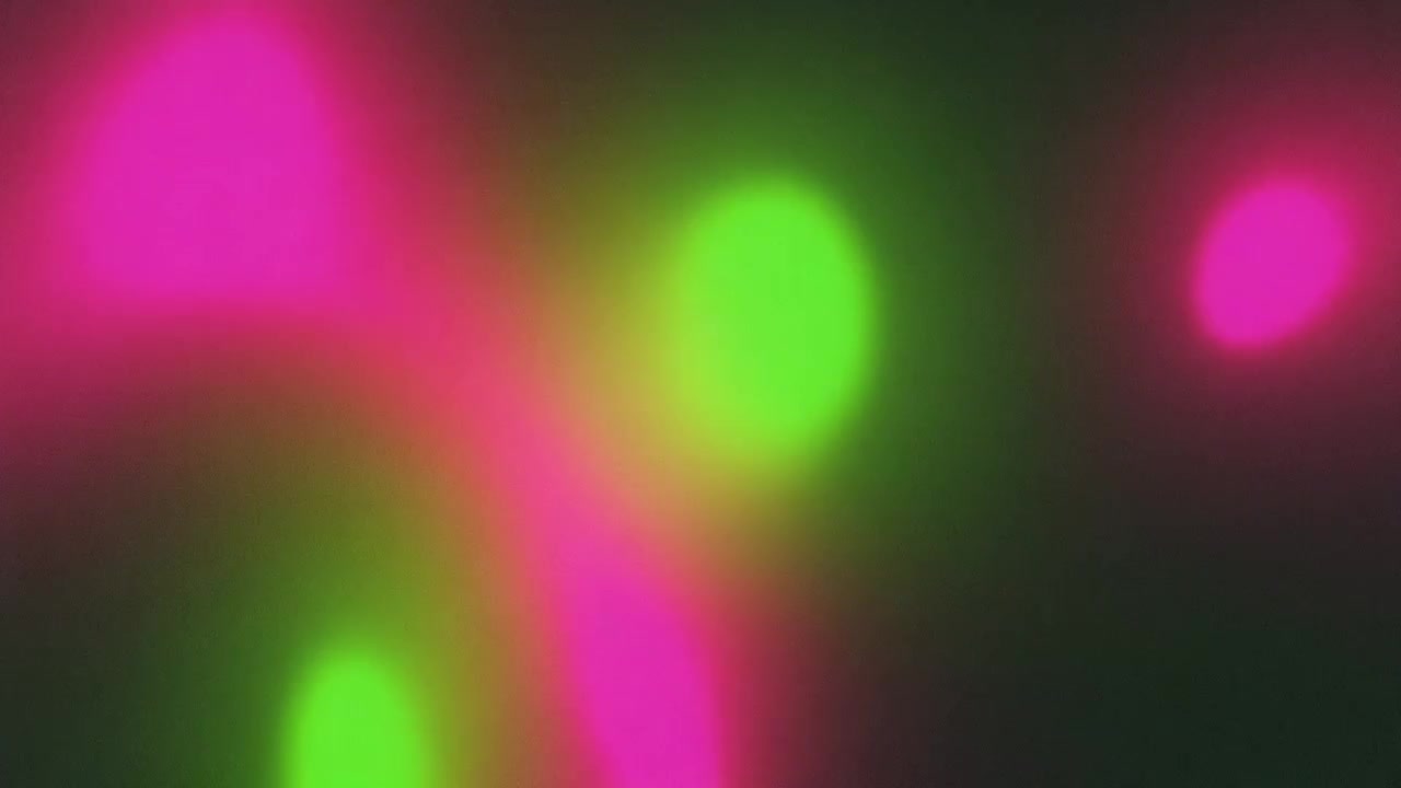 Sfondo astratto con sfere di luce rosa e verde che brillano delicatamente