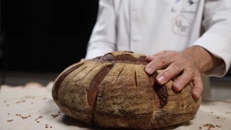 chef preparing and cutting artisan bread