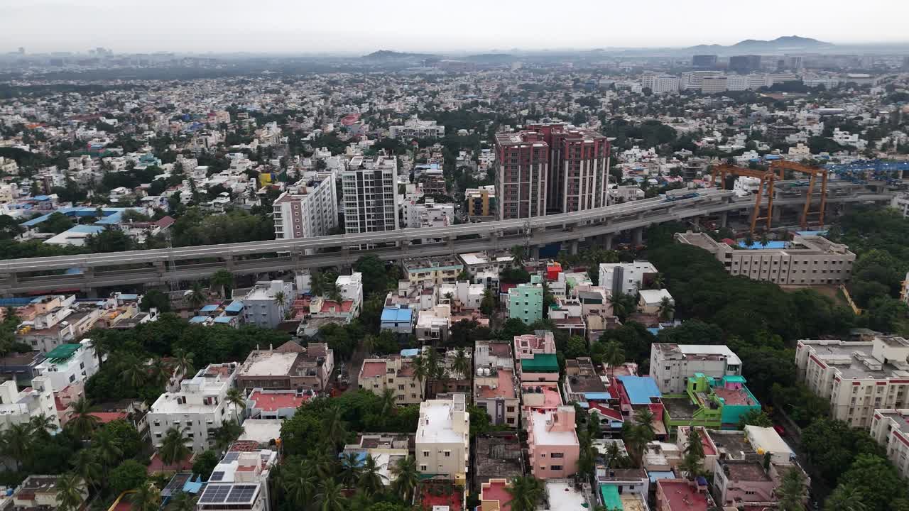 Cinematic aerial footage of the double-decker Metro Rail complex construction of the two-level track on a single row of pillars, highlighting the city's modern public transportation infrastructure