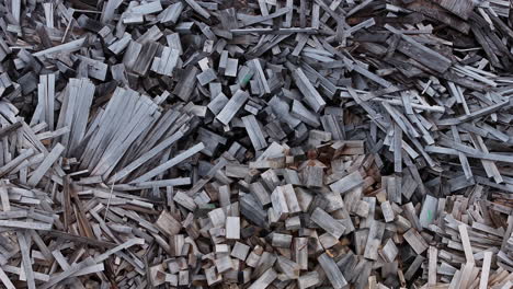 top down aerial footage panning across piles of various wood materials.