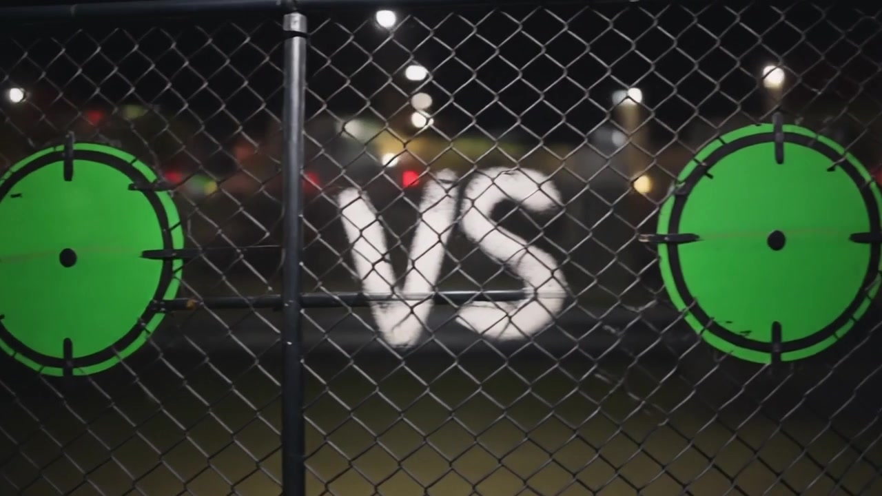 Green Target Signs on Chain Link Fence at Night