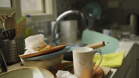 slow pan over a sink full of dirty dishes in the kitchen