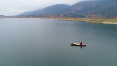 man rowing a boat on a lake 4k