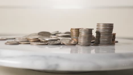 pennies and quarters stacked up on a plate