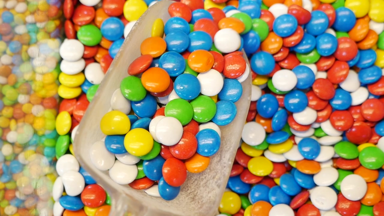 Close-up of Colorful Candies Being Scooped