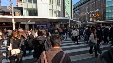 people crossing a busy street in kyoto