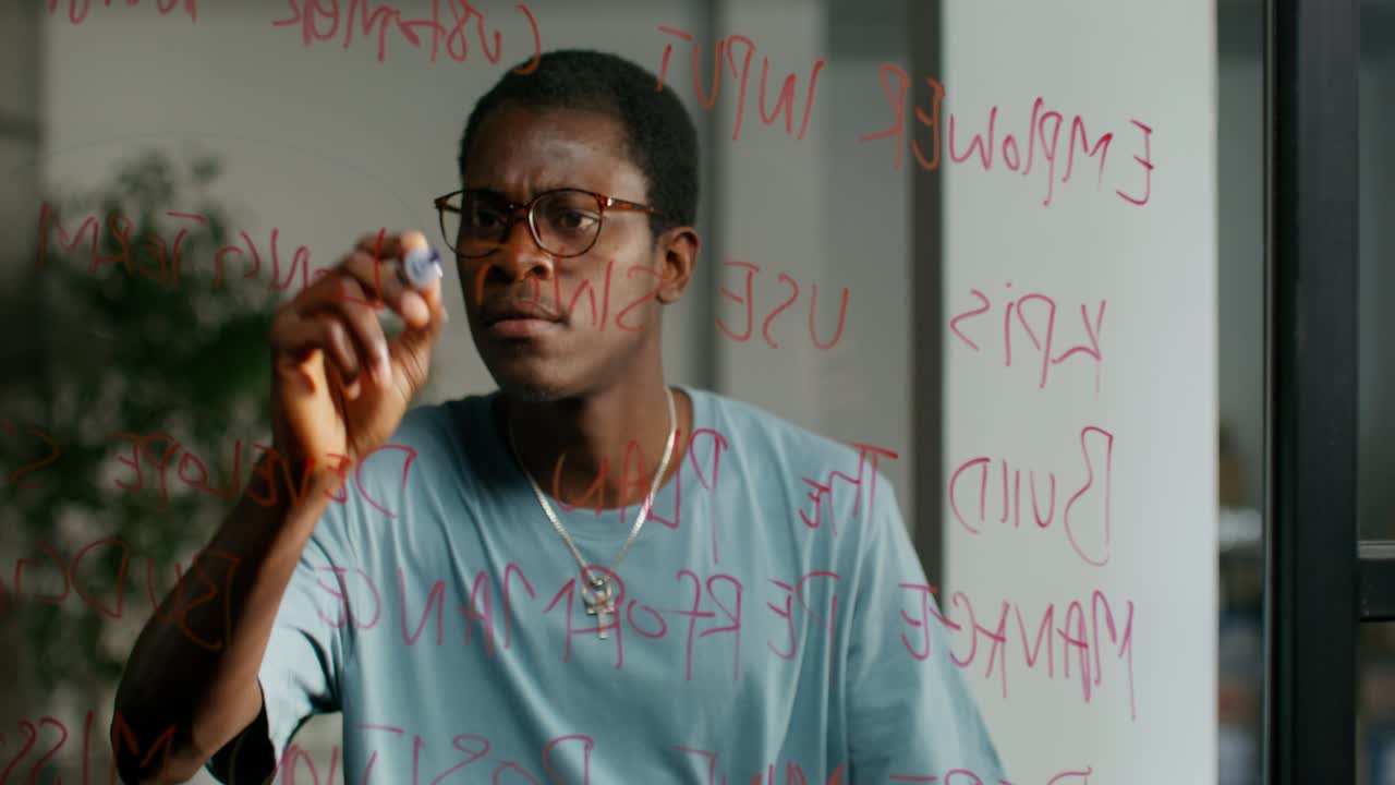 Man writing on a glass board