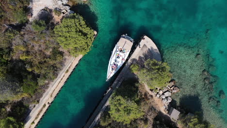 birdseye drone aerial view of boat in canal on adriatic sea coastline, croatia