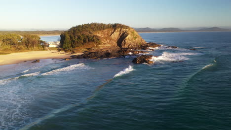 slowly revealing drone shot of rocky outcropping in the ocean at scotts head in australia