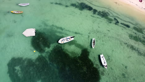 Anchored-speedboats-on-crystal-cleat-water-surface-of-indian-ocean-on-sunny-day