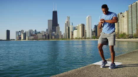 ethnic male doing running workout with smart watch