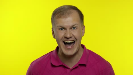 Portrait-of-young-caucasian-man-posing-in-pink-t-shirt.-Satisfied-handsome-guy-shouts,-happy