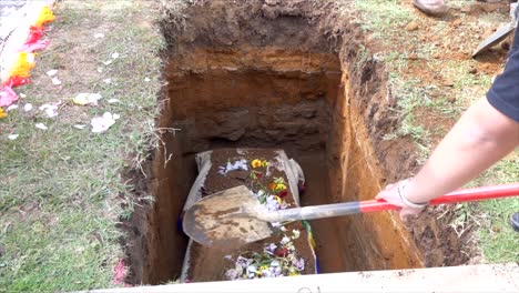 closeup shot of a funeral casket or coffin in a hearse or chapel or burial at cemetery