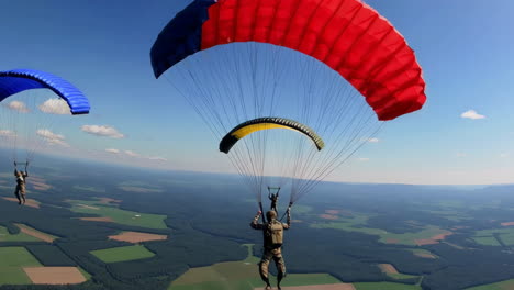 paratroopers skydiving over rural landscape