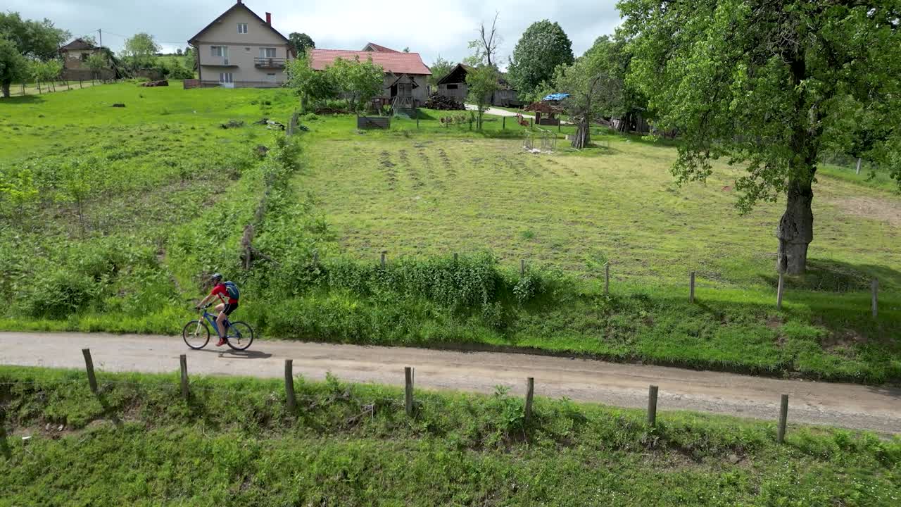 Mountain biker rides a bicycle through the countryside