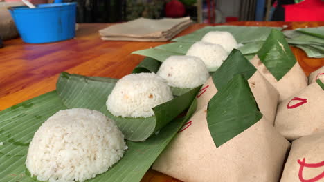 a shot of cooked rice wrap with banana leaf