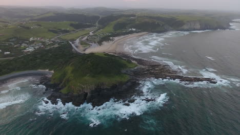 cinematic aerial flying at sunrise over coast of east london south africa