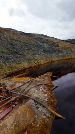 barrick gold open-pit mine in cotui, pumping systems and water management, mining operations, dominican republic. aerial drone fpv, vertical format, copy space