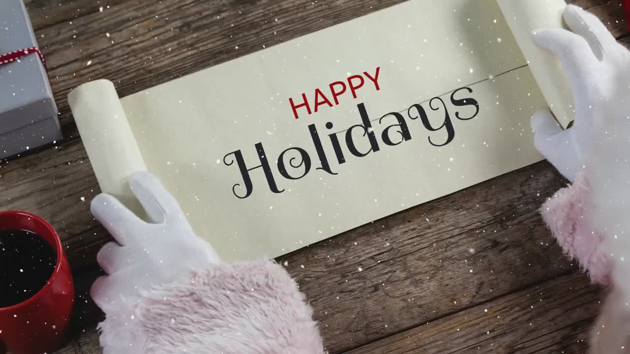 Video composition with snow over desk  with santa  revealing paper roll