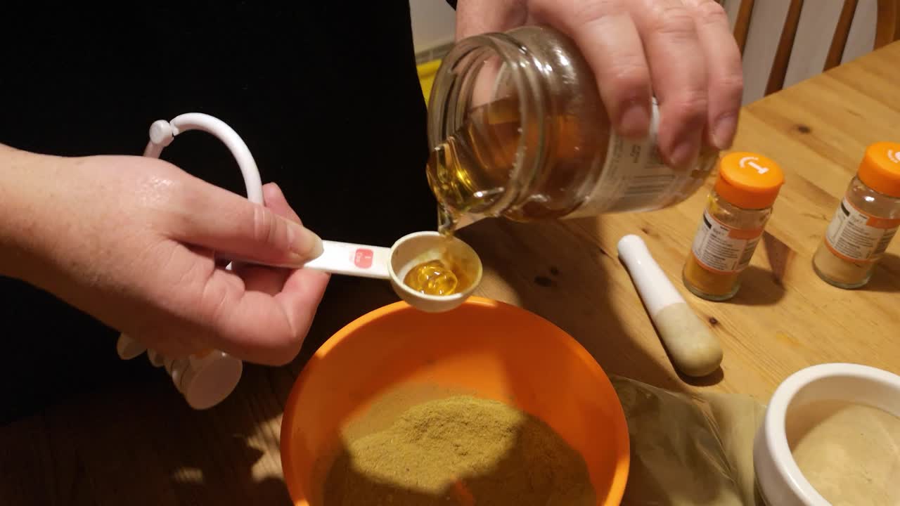 hembra mide miel con moringa y suplemento de medicina herbal en polvo de cúrcuma en la cocina