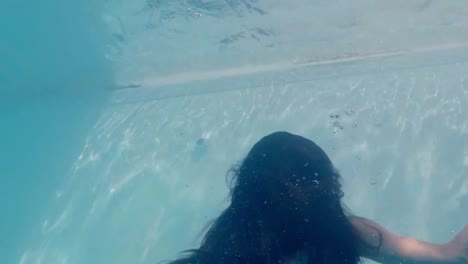 beautiful woman with green dress swimming underwater
