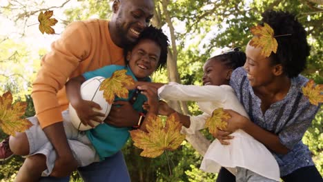 Animation-of-fall-leaves-over-happy-african-american-family-in-autumn-park
