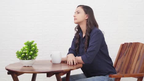 Indian-girl-waiting-for-someone-at-a-cafe