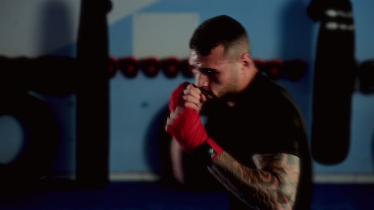 Man training with boxing gloves in a gym