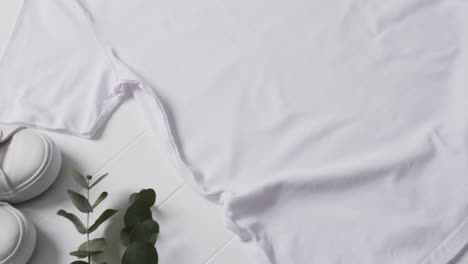 Video-of-flat-lay-of-white-t-shirt-with-copy-space-on-white-background