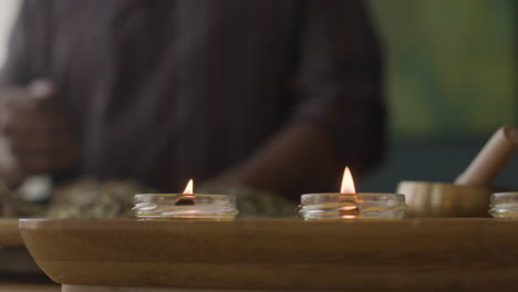 preparing herbal medicine with candles