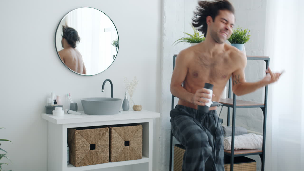 Man Singing and Dancing in Bathroom with Hair Dryer