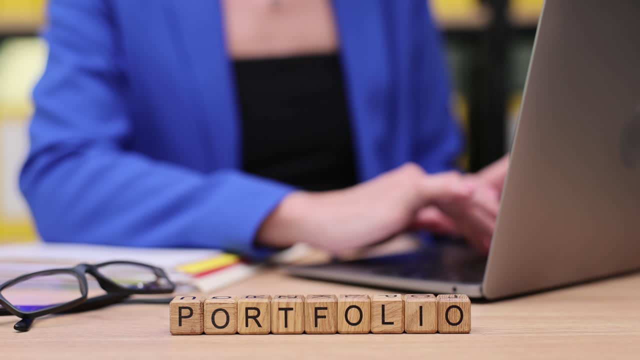 Portfolio on wooden blocks with laptop