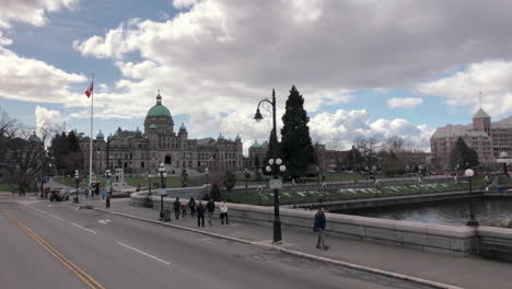 Wide-shot-of-Victoria-parliament-from-moving-vehicle,-sunny-day
