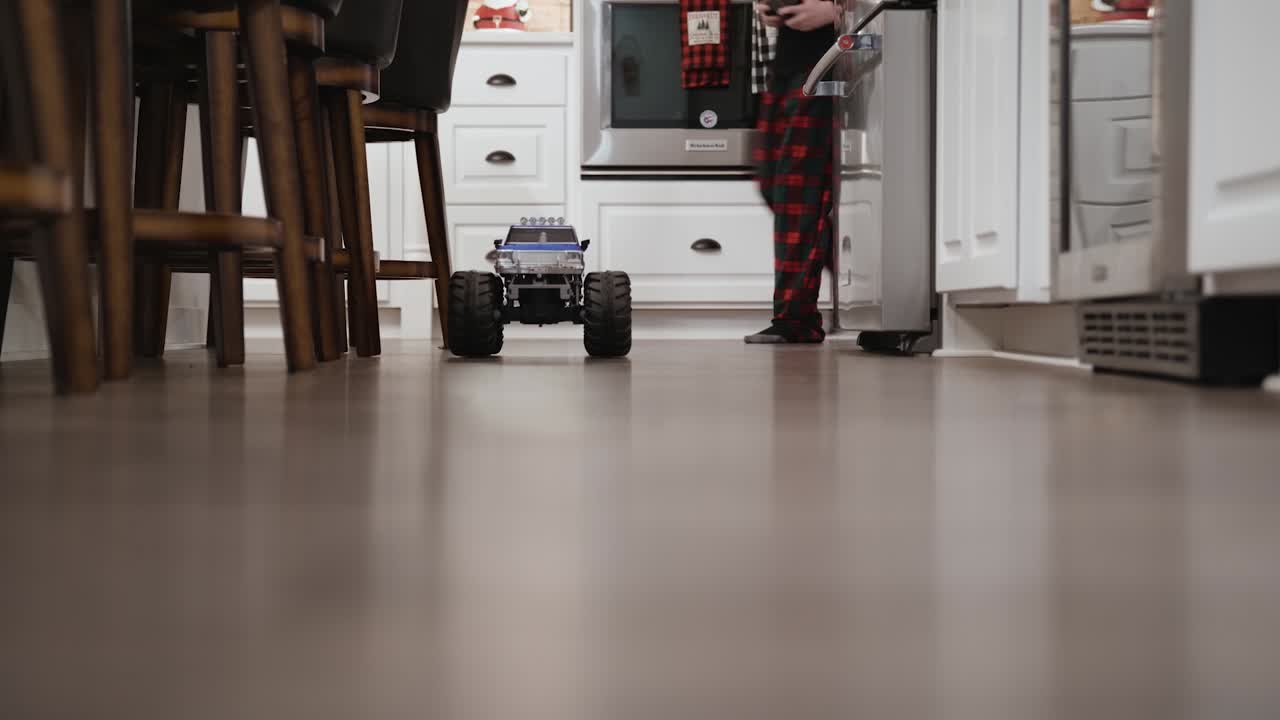 Boy drives his remote control truck on Christmas morning