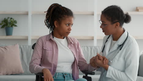 doctor provides compassionate care and emotional support to young woman in wheelchair