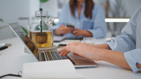 hands typing laptop online on office meeting closeup. corporate worker searching